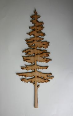 a wooden christmas tree hanging on the wall