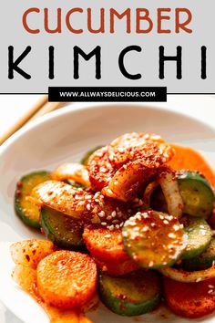 cucumber kimchi in a white bowl with sesame seeds on top and text overlay