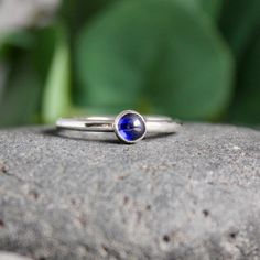 Do you need a gift for someone with a September birthday or to celebrate your 5th wedding anniversary? This sterling silver synthetic sapphire stacking ring is perfect if your birthstone is sapphire or you need a simple navy blue ring. Here are the details:This ring is made with either a rose cut (faceted) or smooth 5mm synthetic sapphire cabochon set in a sterling silver bezel and on a sturdy band handmade in your size. It can be worn with other stackable rings, or by itself.Please select your Stackable Sapphire Rings For Gifts, Stackable Sapphire Rings As Gift, Dainty Stackable Sapphire Ring For Anniversary, Classic Sapphire Birthstone Ring Gift, Adjustable Sapphire Ring With Birthstone, Stackable Sapphire Ring Gift, Blue May Birthstone Jewelry For Anniversary, Blue Sapphire Stackable Birthstone Ring, Dainty Blue Sapphire Stackable Ring