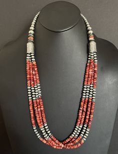 Add a pop of color to your jewelry collection with this stunning multi-strand beaded necklace. The necklace features vibrant red spiny oyster pearls that are perfectly complemented by the .925 sterling silver metal. Measuring 30 inches in length, this beaded necklace is perfect for both casual and formal occasions. The necklace is created in a Southwestern style and is adorned with intricate beading that adds to its unique design. It is a perfect addition to any jewelry collection and is sure to Red Southwestern Style Jewelry Gift, Southwestern Style Red Jewelry For Gift, Southwestern Style Red Jewelry For Gifts, Red Hand-strung Multi-strand Jewelry, Sterling Silver Beaded Multi-strand Jewelry, Southwestern Multi-strand Polished Bead Necklaces, Bohemian Pearl Necklace With Polished Beads In Silver, Bohemian Silver Pearl Necklace With Polished Beads, Hand-strung Round Red Coral Jewelry