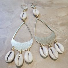 Summer Bohemian Gold Teardrop Earrings, Gold Bohemian Teardrop Earrings For Summer, Shell-shaped Metal Earrings, Metal Shell-shaped Earrings, Silver Metal Jewelry For Vacation, Nickel-free Bohemian Earrings For Vacation, Bohemian Nickel Free Earrings For Vacation, Bohemian Nickel-free Earrings For Vacation, Cowrie Shell Dangle Earrings As Gift