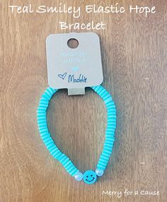 Teal Smiley Elastic Hope Bracelet. This is a handmade teal clay bead bracelet featuring a smile bead.  This bracelet measures 21/2 inches and is elastic. Hope Bracelet, Clay Bead Bracelet, Clay Bead, Clay Beads, Bead Bracelet, A Smile, Smiley, Jewelry Bracelets, Beaded Bracelets