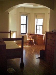 a bedroom with wooden floors and white walls