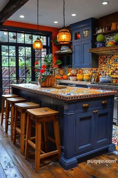 a kitchen with blue cabinets and an island in the center, surrounded by wooden stools