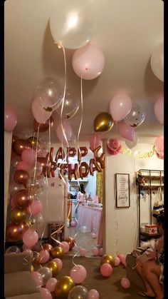 a room filled with lots of balloons and streamers