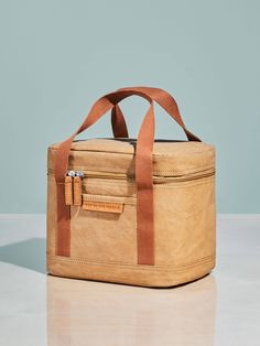 a tan bag sitting on top of a white table