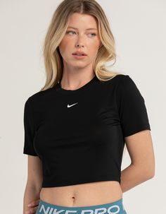 Nike Sportswear Essential Slim Crop Tee. Embroidered Nike Swoosh Logo On Center Chest. Ribbed Crew Neckline. Short Sleeve. Slim Fitting, Cropped Fit. 49% Polyester, 48% Modal, 3% Spandex. Machine Wash. Imported. Model Is Wearing A Size Small. Model Measurements:height: 5'8" Bust: 33"waist: 26"hips: 36 1/2" Sporty Workout T-shirt, Spring Gym T-shirt With Crew Neck, Sporty Crew Neck Crop Top For Workout, Spring Athleisure Cropped T-shirt For Sports, Nike Cropped Short Sleeve T-shirt For Sports, Sporty Crew Neck Crop Top, Sporty Cropped T-shirt For Spring Workout, Sporty Moisture-wicking Crew Neck Crop Top, Sportswear Crop Top With Crew Neck For Gym