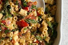 a white bowl filled with pasta and vegetables