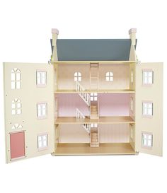 a doll house with stairs and windows on the front, pink walls and white floors