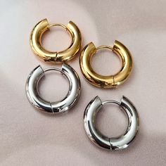 Get on trend this summer with these chunky and thick huggie hoops in either gold or silver tone. This is a beautiful and fun pair of stainless steel chubby huggies in either 12mm or 16mm. You can choose between rhodium silver plated or gold plated and enjoy these in fashion hoops all beach day long! All earrings come beautifully and simply packaged in a box and bow ready for gifting. CARE INSTRUCTIONS• It is not recommended to sleep, shower or exercise in plated jewelry. Trendy Small Hoop Stainless Steel Earrings, Trendy Stainless Steel Huggie Hoop Earrings, Trendy Chunky Hoop Earrings Gift, Trendy Chunky Hoop Earrings For Gifts, Huggies Hoop Earrings, Crown Decor, Chunky Gold Hoop Earrings, Earring Trends, Jewish Gifts