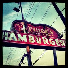 an old sign for a hamburger restaurant