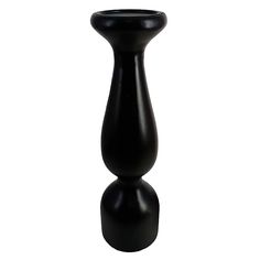 a black vase sitting on top of a white table