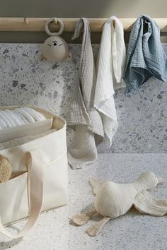 a white bag sitting on top of a counter next to a stuffed animal and other items