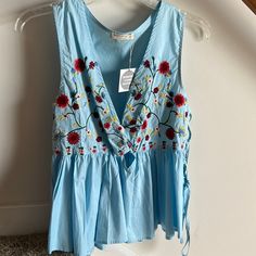 Whimsical And Sweet Peplum Tank. I’d Keep It But It No Longer Fits. Never Worn, Nwt. Casual Blue Embroidered V-neck Top, Light Blue Floral Embroidered V-neck Top, Blue V-neck Top With Floral Embroidery, Light Blue Embroidered V-neck Top, Light Blue Embroidered Tops For Spring, Light Blue Embroidered Summer Blouse, Blue Sleeveless Embroidered Top For Summer, Blue Cotton Embroidered V-neck Top, Sleeveless Floral Embroidered Blouse For Spring