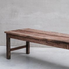 a wooden bench sitting on top of a white floor