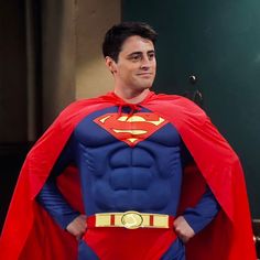 a man in a superman costume standing with his hands on his hips