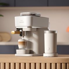 an espresso machine sitting on top of a wooden table