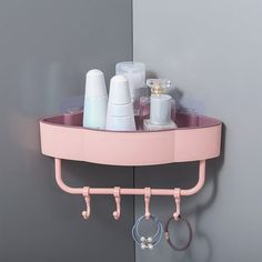 a pink shelf that has some items on it