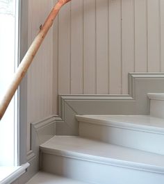 a wooden stick sticking out of the side of a set of stairs