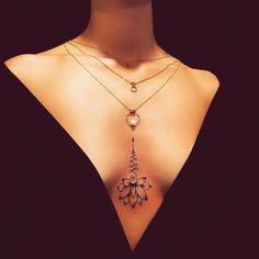 a woman's back with a necklace on it