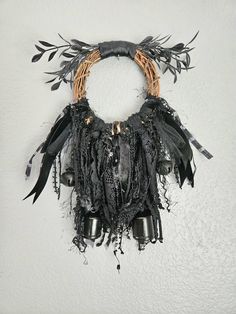 a piece of art that looks like it has been made out of feathers and metal bells