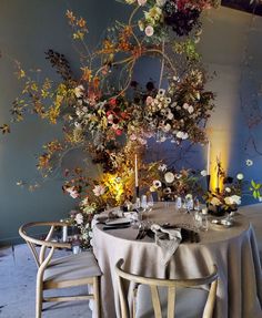 the table is set with flowers and candles for an elegant dinner or party event,