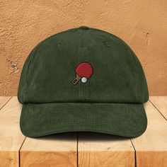 Great gift for ping pong lover! A hat made of corduroy? That's a yes! Get your hands on a hat that'll serve you for ages. The corduroy fabric has stood the test of time thanks to its best features--softness, affordability, and durability. Get yours now! * 100% cotton corduroy * Soft, unstructured crown * Cotton twill sweatband and taping * Adjustable buckle * Blank product sourced from China 📌 If you'd like to purchase this design on a different product, don't hesitate to reach out! 📌 For example: Classic Dad Hats, Snapback Hats, Trucker Hats, Camper Caps, Beanies, Denim Caps, Vintage Hats, Flat Bill Caps, Distressed Dad Hats, Visors and MORE (Hoodies, T-Shirts, Mugs, Phone Cases and more). 📌 We can also change the colors of the embroidery at your request! This product is made especiall Embroidered Corduroy, Corduroy Hat, Motif Simple, Hat Handmade, Dad Cap, Embroidered Caps, Corduroy Fabric, Rigatoni, Plush Fabric