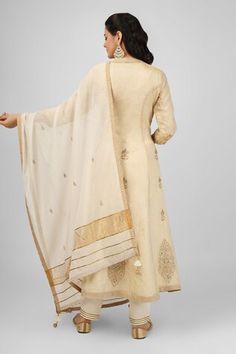 Ivory long jacket with floral embroidery using zari and sequins. Paired with an inner anarkali and pant. Comes along with a dupatta. - Aza Fashions Cream Chikankari Embroidery Anarkali Set In Raw Silk, Cream Chanderi Traditional Wear With Embroidered Border, Cream Embroidered Raw Silk Anarkali Set, Festive Off White Sharara With Embroidered Border, Cream Anarkali Unstitched Silk Suit, Cream Chanderi Anarkali Set With Resham Embroidery, Cream Salwar Kameez With Embroidered Border For Festivals, Embroidered Cream Anarkali Set For Transitional Season, Long Sleeve Anarkali Set With Embroidered Border For Wedding