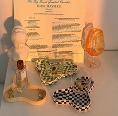 a display case with various items on it including soap, perfume bottle and napkins