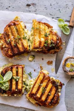 grilled cheese sandwiches on parchment paper with herbs