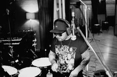 a man with headphones on playing drums