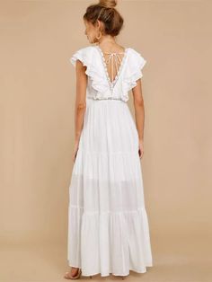 Are you looking for the chicest boho dresses in town? Look no further than our exclusive piece in pristine white, with captivating ruffle detailing at the neck. This boho maxi dress in white, with an empire waistline and a dreamy a-line silhouette can transform you into an ethereal goddess. Wear this ultimately stunning bohemian dress or pair it with statement boho jewelry and stilettos for a truly stunning look. Sleeveless Ruffled V-neck Polyester material Ankle-length boho maxi Solid pattern H Beach Floor-length Maxi Dress With Ruffles, Floor-length Ruffled Maxi Dress For Beach, Flowy White Maxi Dress For Brunch, Beach Maxi Dress With Ruffles, Elegant White Tiered Maxi Dress, White Floor-length Boho Dress For Vacation, Elegant White Floor-length Boho Dress, Chic Maxi Dress For Beach Wedding, White Flowy Floor-length Boho Dress