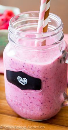 a pink smoothie in a mason jar on a table