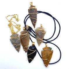 Our Gold Wire Wrapped Stone Arrowhead Pendant Necklace is a symbol of strength and protection. Native American Indians wore Arrowhead Pendant Necklaces to keep them protected against negative energy and sickness.  With an arrowhead pendant on your neck, you are protected and guarded as you journey through life. Our Gold Wire Wrapped Stone Arrowheads come in all different sizes and pictures on  display describe the general design of our Arrowheads. Disclaimer!! Do not wear your Wire Wrapped Crystals/Gemstones Jewelry in the Shower, Working Out or to Bed. Keep stones away from chemicals. Treat your Wire Wrapped Crystal/Gemstone jewelry with the utmost care for longevity. All of my Wire Wrapped Crystals/Gemstones have been cleansed and charged. This is done to ensure that any negative energie Arrowhead Wire Wrapped Necklaces For Gifts, Adjustable Wire Wrapped Arrowhead Necklace, Wire Wrapped Arrowhead Necklace For Gift, Spiritual Arrowhead Necklace Gift, Adjustable Arrowhead Necklace Gift, Nickel Free Arrowhead Necklace For Gift, Nickel-free Arrowhead Necklace Gift, Nickel-free Arrowhead Necklace For Gift, Handmade Spiritual Arrowhead Necklace