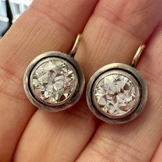 As an earring lover, this pair of old cut diamonds checks off all the boxes for me: Size/carat weight, check. Beauty, check. Sparkle, check. Wearability, check and check! The old European cut diamonds are chunky and lively. They sit elegantly on the lobes, with the diamonds catching the light so beautifully! Perfect to wear during both day and night. Silver on 18kt yellow gold Diamonds are estimated to be P/Q colors & VVS clarities Please see qualitative report for more information. Video Below Vintage Platinum Earrings With Brilliant Cut, Vintage Round Platinum Diamond Earrings, Vintage Platinum Round Diamond Earrings, Vintage Platinum Earrings, Vintage Diamond Earrings With Single Cut Diamonds, Antique Brilliant Cut Diamond Earrings, Vintage Diamond White Single Cut Diamond Earrings, Victorian Diamond White Diamond Earrings For Formal Occasions, Victorian Diamond White Earrings For Formal Events