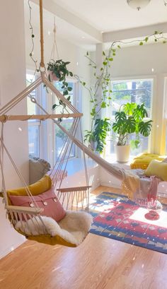 a living room filled with furniture and plants