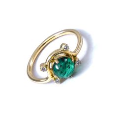 -PRODUCT TYPE - GOLD EMERALD WITH DIAMONDS RING -MATERIAL - GOLD -PURITY - 18K -DIAMOND - 0.07 - APPROX CARAT -STONE - EMERALD - 1.1 - APPROX CARAT -TOTAL WEIGHT - 2.5 - APPROX GRAMS -GOLD WEIGHT - 2.2 - APPROX GRAMS - This piece signifies simplicity that itself is sign of class. Here, we present the essence of diamond with mesmerizing emerald stone. We bet you will love it! -Quality is guaranteed. Our mission is always to satisfy our customers with our offerings, so just relax and place order! Yellow Gold Halo Ring With Emerald, Yellow Gold Emerald Halo Ring With Round Cut, Yellow Gold Rings With Polished Finish And Round Stone, Emerald Jewelry For Promise Ring With Polished Finish, Gold Rings With Emerald And Halo Setting, Formal Gold Rings With Emerald, Yellow Gold Rings With Round Cut Emerald, 14k Gold Emerald Ring With Center Stone, Emerald Ring With Round Shape