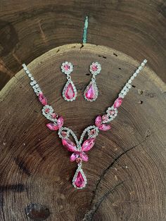 "Fuchsia earrings and necklace set! These fun and stylish pink teardrop cluster crystal rhinestone necklace and earrings set are a great statement piece!  Size of earrings: 1.2\" Long.  Necklace 16.5\"long with 4\" chain extender Decor Size: 2\" Color: hot pink/fuchsia and clear  rhinestones  Base metal color: silver More colors available upon request, just message us! Need a matching bracelet? https://www.etsy.com/listing/607744629/fuchsia-bracelet-hot-pink-bracelet?ref=shop_home_active_59 https://etsy.me/2UTFrJ4  https://etsy.me/2VJu5W8  https://etsy.me/3hBB6Uo  Looking for the perfect pair of earrings for a special occasion. We specialize in custom work in fashion jewelry, pearls, and natural stones! Please feel free to browse through our other listings, and if you can't find what you a Elegant Pink Rhinestone Jewelry Set, Pink Crystal Rhinestone Necklace With Sparkling Stones, Pink Teardrop Jewelry For Party, Pink Teardrop Crystal Jewelry, Pink Crystal Jewelry Sets With Rhinestones, Pink Rhinestone Party Necklaces, Pink Rhinestone Party Necklace, Pink Party Jewelry Sets With Sparkling Stones, Pink Sparkling Stones Jewelry Set For Party