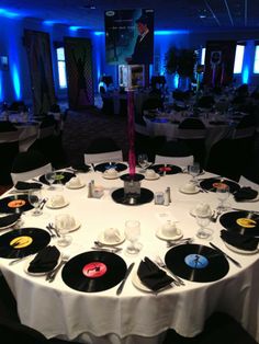 a round table is set with black and white plates