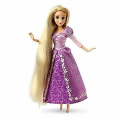 a barbie doll with long blonde hair and purple dress, holding her hand out to the side