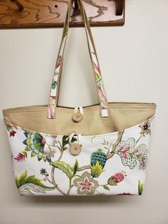 This attractive bag is roomy enough to carry all a girl's essentials and a little more.   The bag measures approximately 15 in wide x 11 in tall x 6 in.  The handles have about a 13 inch drop from center. There are 4 open pockets and a pocket witha button loop closure inside and an outer pocket.   Could also be used as a baby bag.   It is made from indoor decor fabric so it is heavier duty. Pouch Shoulder Bag With Handle Drop For Shopping, On-the-go Beige Diaper Bag With Double Handle, Handheld Canvas Bag With Removable Pouch For On-the-go, Handheld Hobo Bag With Handles For Travel, Large Beige Satchel For Daily Use, Handheld Canvas Hobo Bag For Travel, Large Beige Travel Satchel, Large Beige Satchel, Large Capacity Satchel Diaper Bag For Shopping