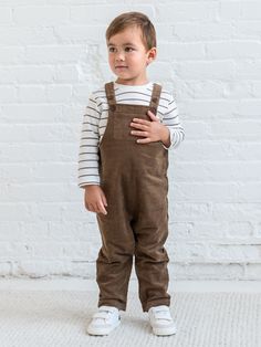 Welcome the season with the Remi Corduroy Overall, designed for both style and functionality. Featuring adjustable button straps for a customizable fit, this overall includes front and back patch pockets for handy storage. The side buttons make it easy to slip on and off, while the snap leg opening and crotch gusset ensure quick and convenient diaper changes. The soft corduroy fabric adds warmth and durability, making it perfect for fall and winter adventures. The Remi Corduroy Overall combines Brown Cotton Overalls For Spring, Brown Cotton Overalls With Pockets, Brown Cotton Overalls, Cotton Bib Front Overalls With Button Closure, Brown Corduroy Overalls With Pockets, Playtime Overalls With Pockets And Bib Front, Utility Cotton Overalls With Buttons, Fall Cotton Overalls With Adjustable Straps, Cotton Overalls With Adjustable Straps For Fall