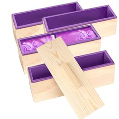 three wooden boxes with purple designs on them