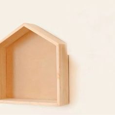 an unfinished wooden shelf mounted on the wall