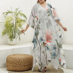 Indulge in elegance and comfort with our V-Neck Kimono Dress, a luxurious addition to your lounge and sleepwear collection.  Crafted from imitation silk (97% polyester and 3% spandex), this robe drapes beautifully and feels incredibly soft against the skin.  The regular fit silhouette ensures a comfortable and flattering wear, while the V-neck adds a touch of sophistication.  Perfect for lounging at home or as a stylish cover-up, this kimono dress is a thoughtful gift for any woman who deserves White V-neck Floral Print Kaftan, White Printed V-neck Kaftan, V-neck Printed Loungewear Dress, Printed V-neck Loungewear Dress, Floral Print V-neck Maxi Dress For Loungewear, Daywear V-neck Printed Kaftan, V-neck Spring Dresses For Home, Floral Print V-neck Free Size Kaftan, Free Size Floral Print V-neck Kaftan