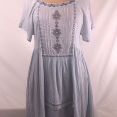 Stunning! This Is Such A Pretty Bluewater Navy, Gray And Silver Details. Square Neck In Front W Open Back High Low Hem. Comes Adjustable Cotton Slip. Two Side Pockets!!! I Bought This For Myself But Sadly Cannot Yet Wear A Small. Free People At Its Best Light Blue Short Sleeve Vacation Dress, Light Blue Short Sleeve Dress For Vacation, Light Blue Cotton Bohemian Dress, Light Blue Casual Short Sleeve Dress, Breezy Short Sleeve Mini Dress For Spring, Blue Cotton Sundress With Short Sleeves, Blue Breezy Sundress For Spring, Blue Cotton Short Sleeve Sundress, Light Blue Cotton Sundress For Spring