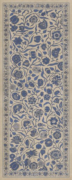 a blue and white rug with flowers on it