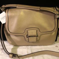 This Coach Cross Body Champagne Colored Bag Is So Soft And A Really Nice Size That Is Great For Everyday Or Traveling. It Has Plenty Of Pockets. This Is A New Bag That Still Has Some Of The Protective Covering Attached But Some Has Been Removed To Show More. No Scratches Or Scuffs. Great For This Summer And Fall. Beige Office Bag With Silver-tone Hardware, Beige Flap Shoulder Bag With Branded Hardware, Elegant Satchel With Silver-tone Hardware And Flap, Elegant Flap Satchel With Silver-tone Hardware, Flap Bag With Silver-tone Hardware, Coach Beige Soft Leather Satchel, Coach Soft Leather Beige Satchel, Leather Cross Body Purse, Burgundy Bag