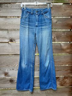 "Vintage 1970's light wash flared jeans. Overall good condition. There was reinforced denim sewn on the inner thigh and near the belt loops on the back right side. The fabric is also thinning on the butt area. See photos for details. Sold as is. Size best for an XS.  Measurements: 38.5\" length  29\" inseam 9\" pant opening 9.25\" thigh width  10.5\" rise 33\" hip 27\" waist" Full Length Medium Wash Flare Jeans With Belt Loops, Retro Wide Leg Light Wash Flare Jeans, Retro Full-length Light Wash Flare Jeans, Vintage Light Wash Full Length Jeans, Vintage Light Wash Jeans With Belt Loops, Retro Light Wash Full Length Jeans, Vintage Light Wash Wide Leg Bottoms, Light Wash Vintage Wide Leg Bottoms, Retro Medium Wash Full Length Flare Jeans