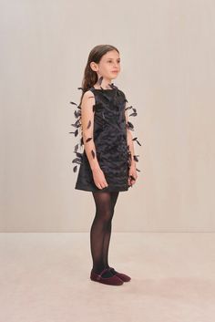 An a-line mini dress adorned with feathers that has a center back zipper. — Mini length — Boat neck — Woven fabric — Center back zipper Boat Neck, Woven Fabric, Feathers, A Line, Black Dress, Mini Dress, Zipper, Fabric, Black